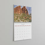 Calendar with a scenic view of red rock formations on a light gray background