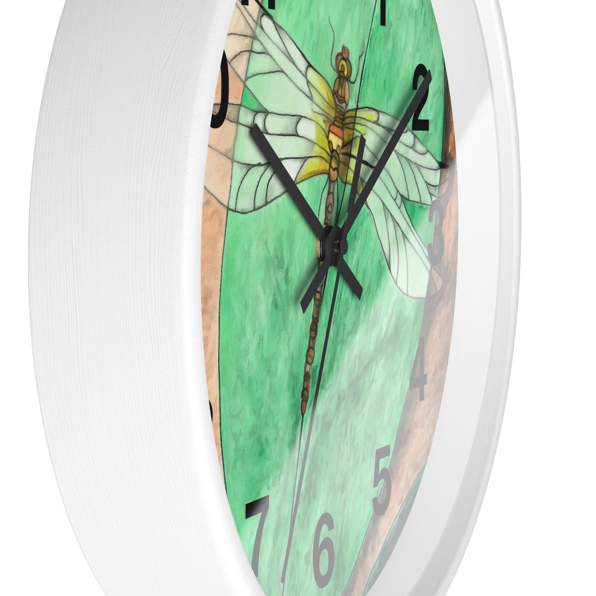 Wall clock with a dragonfly design on a green background