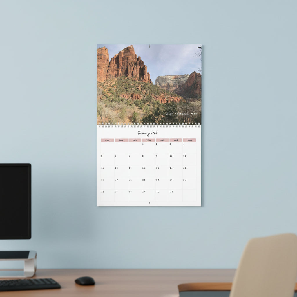 Calendar with Zion National Park landscape on a light blue wall in an office