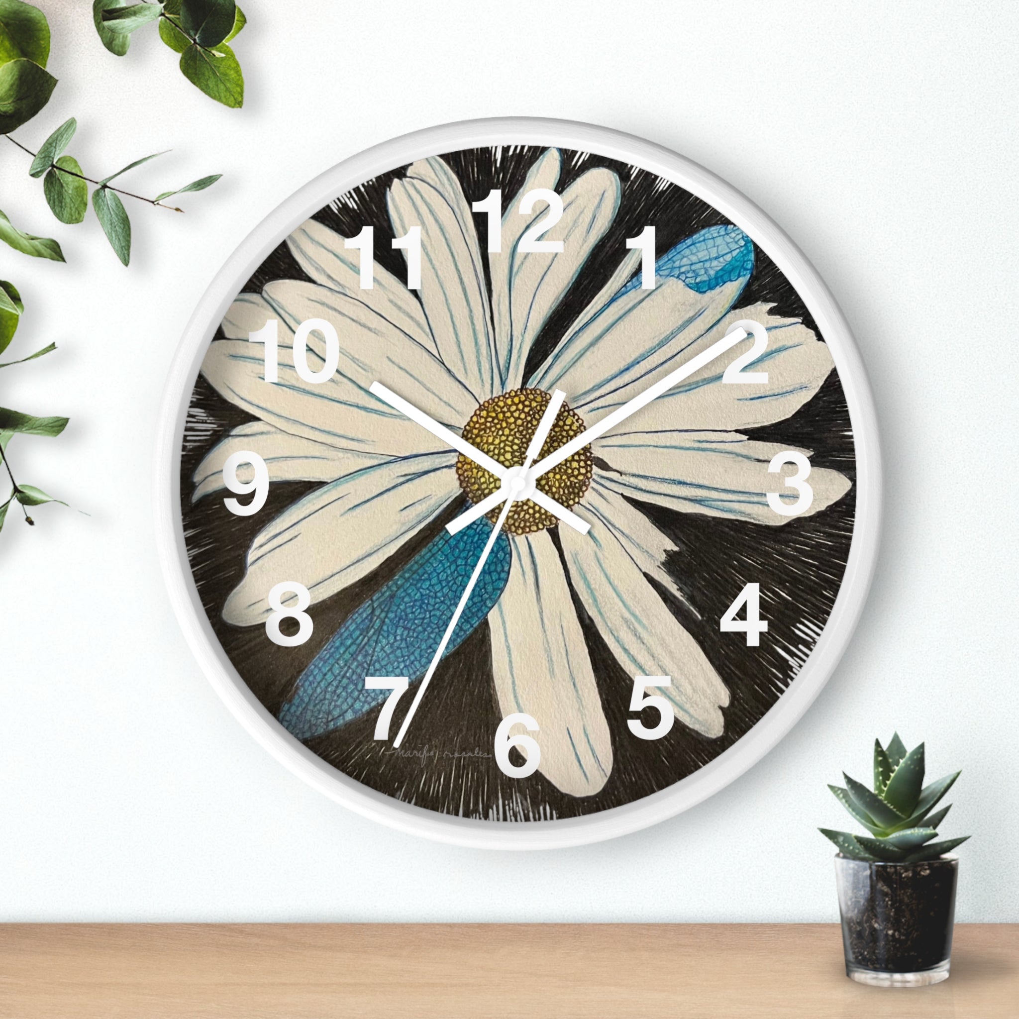 Wall clock with a floral design on a white wall.