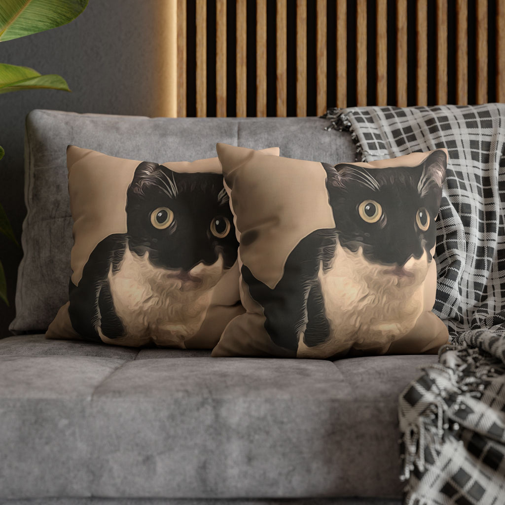 Two cat-themed pillows on a gray sofa with a wooden panel background.