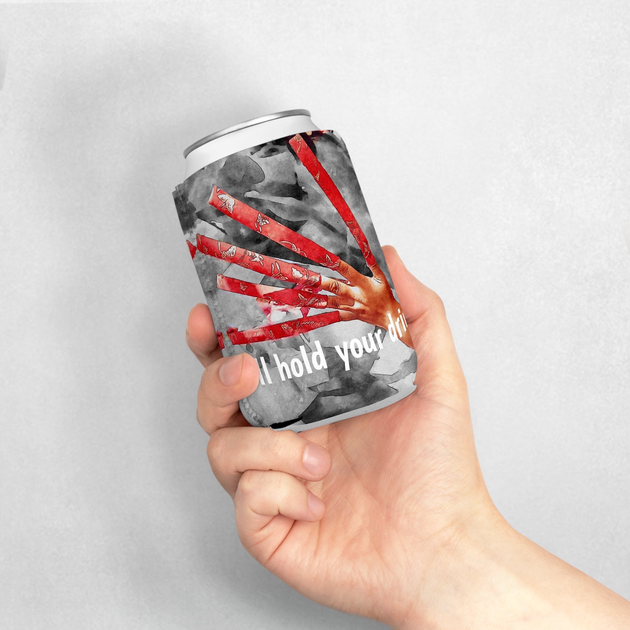 Hand holding a can with a graphic design and text on a gray background