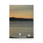 beach landscape with a silhouette of mountains and the ocean