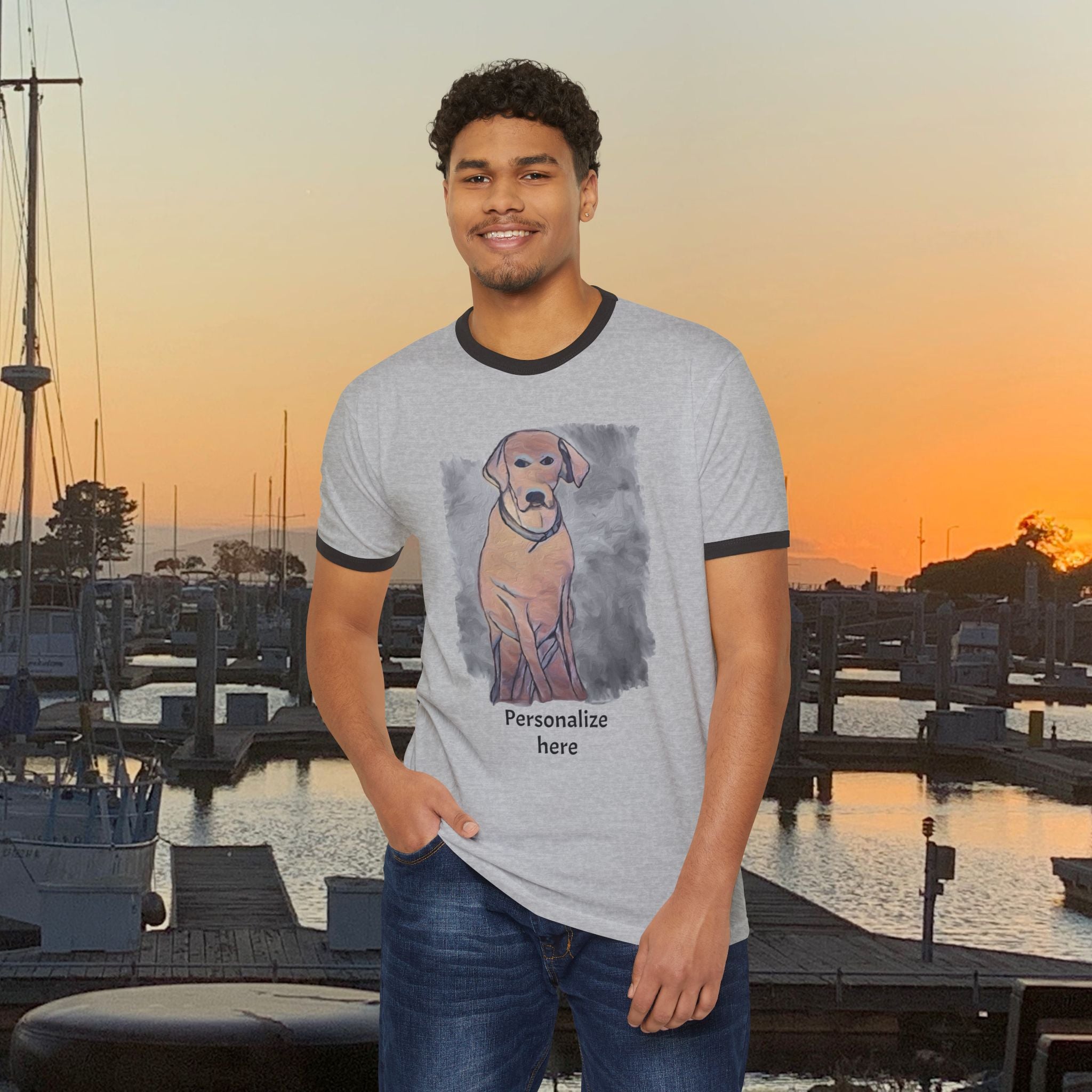 Man wearing a t-shirt with a dog graphic and text at a marina during sunset.