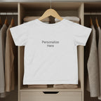 Gray kid t-shirt hanging in a closet with 'Personalize Here' text