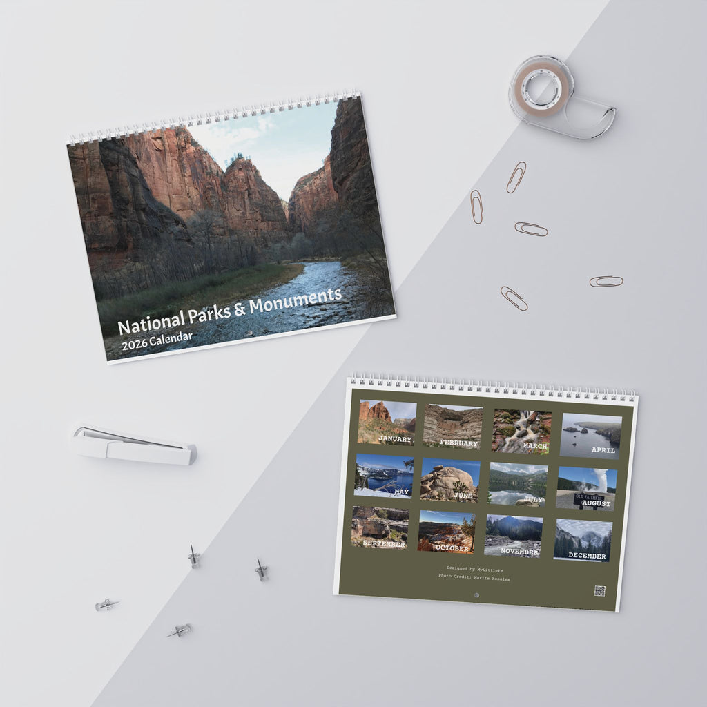 Two national parks calendars on a white surface with office supplies.