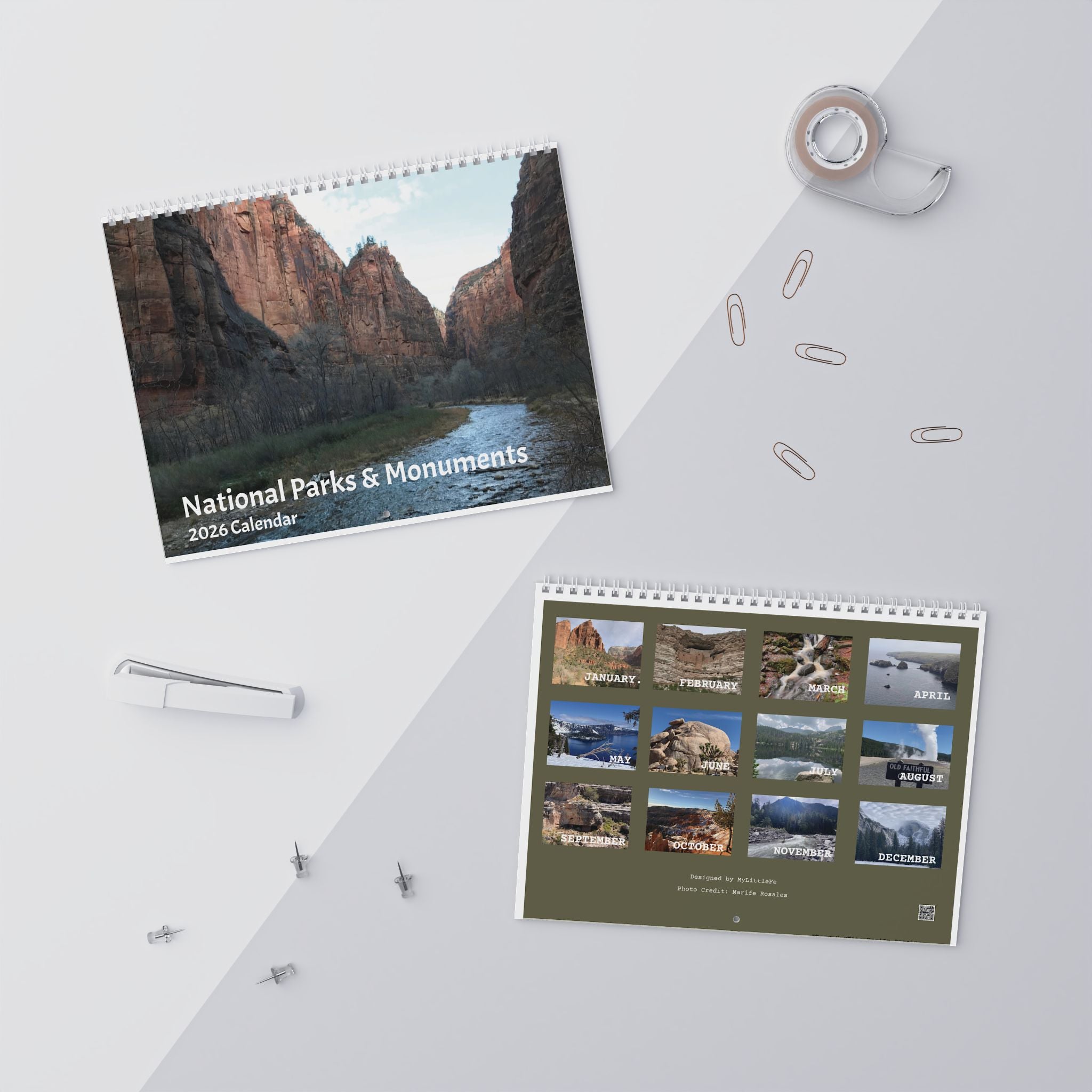 Two national parks calendars on a white surface with office supplies.