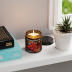 Candle in a decorative jar with a plant and books on a shelf