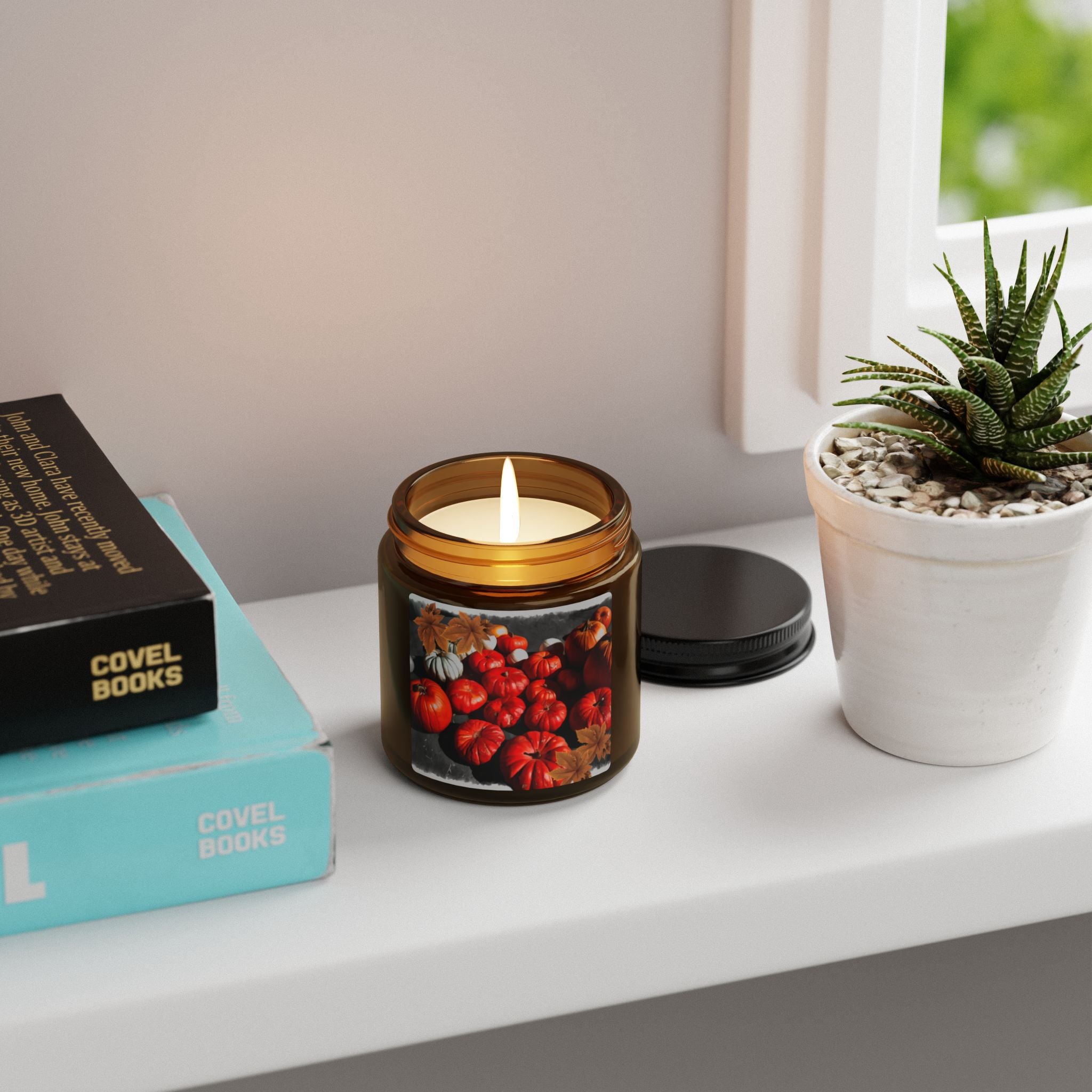 Candle in a decorative jar with a plant and books on a shelf