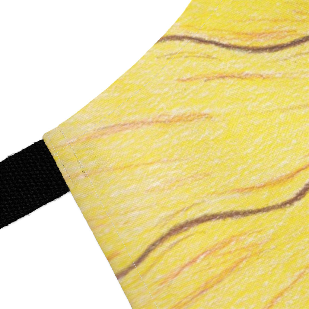 Close-up of a yellow fabric with brown lines and a black strap on a white background