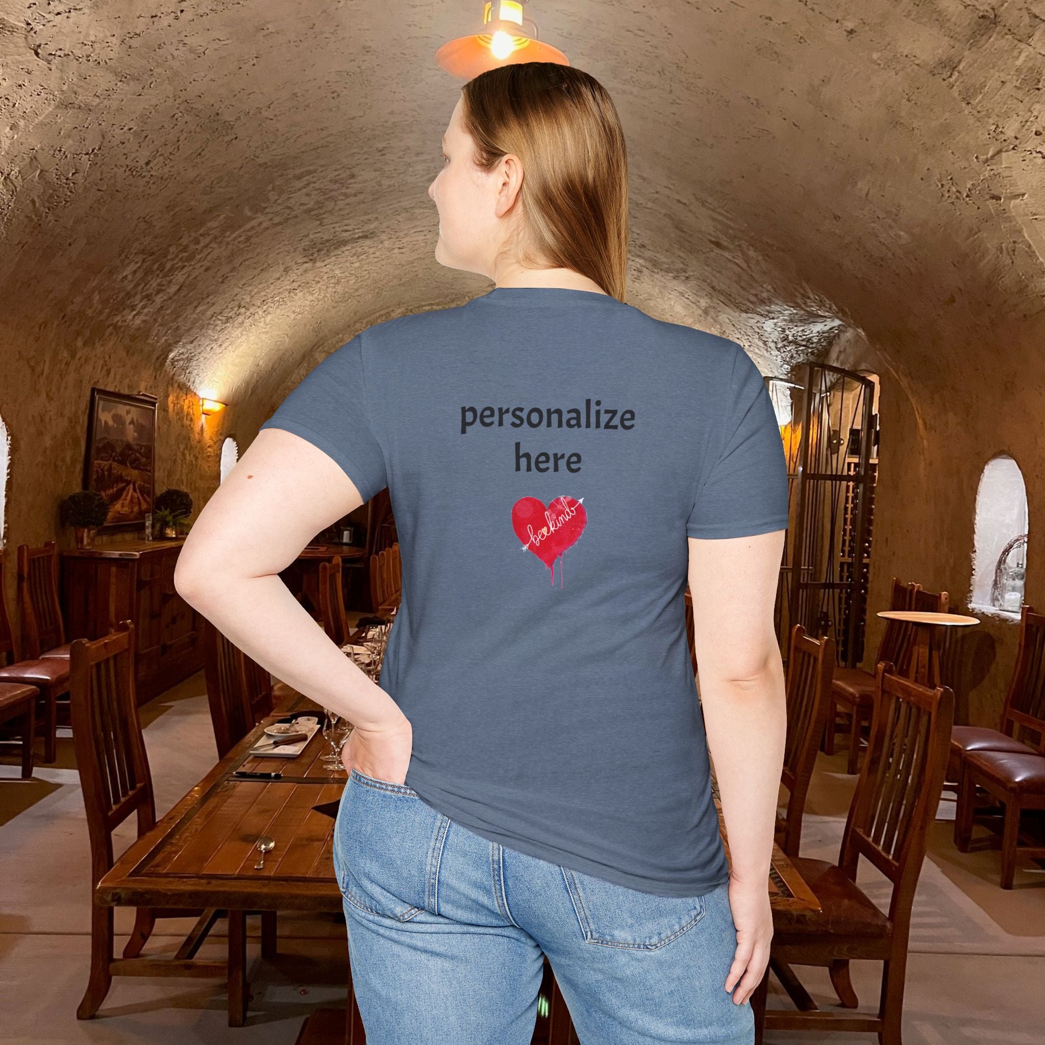 Person wearing a blue t-shirt with customizable text and heart design in an indoor setting.