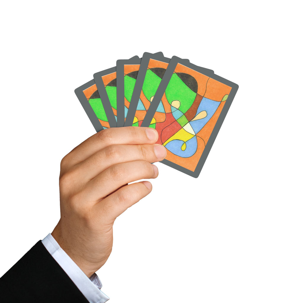 Hand holding a set of colorful playing cards against a white background