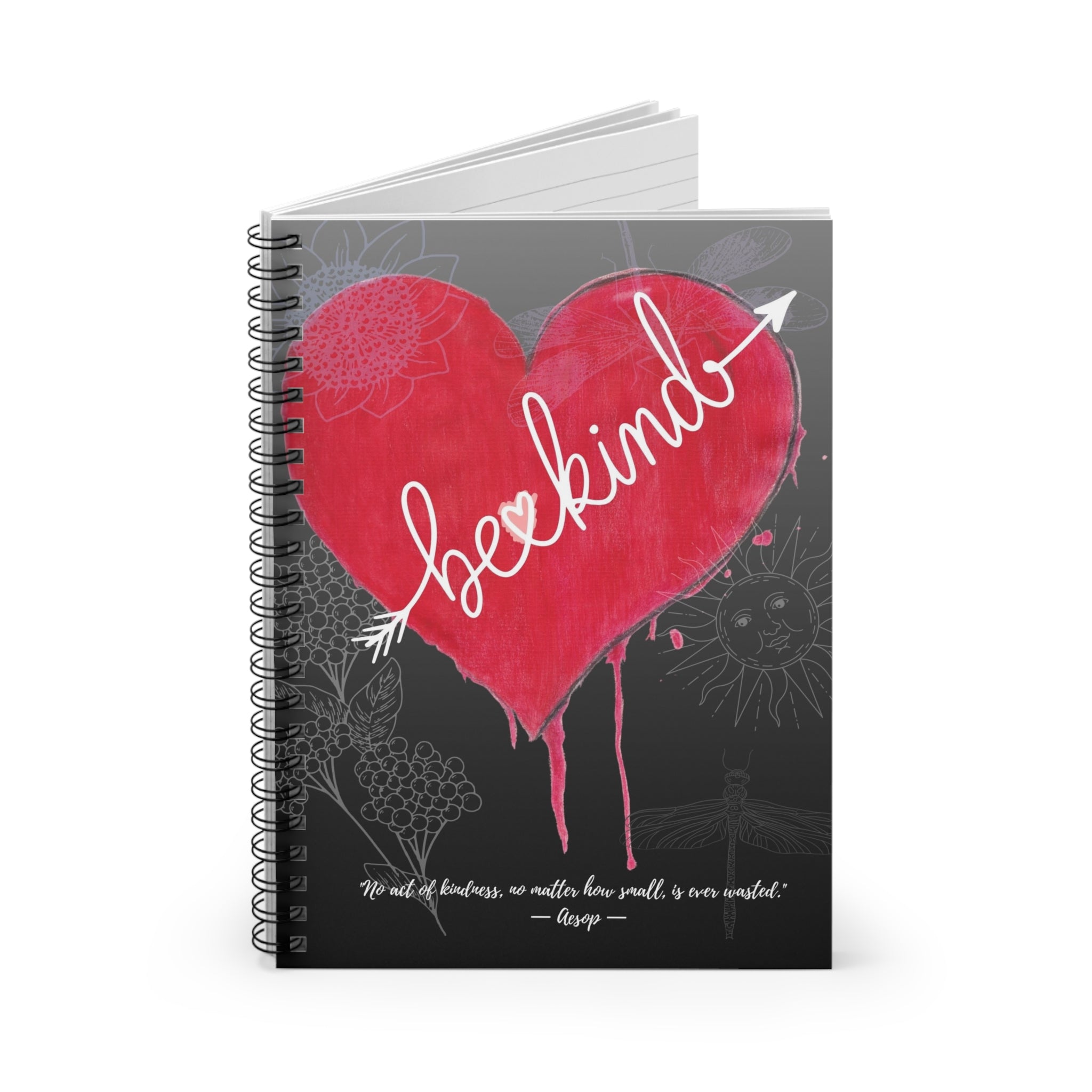 Notebook with a red heart and 'be kind' text on a gray background