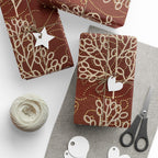 Gift-wrapped items with decorative ribbons, tags, and scissors on a white surface