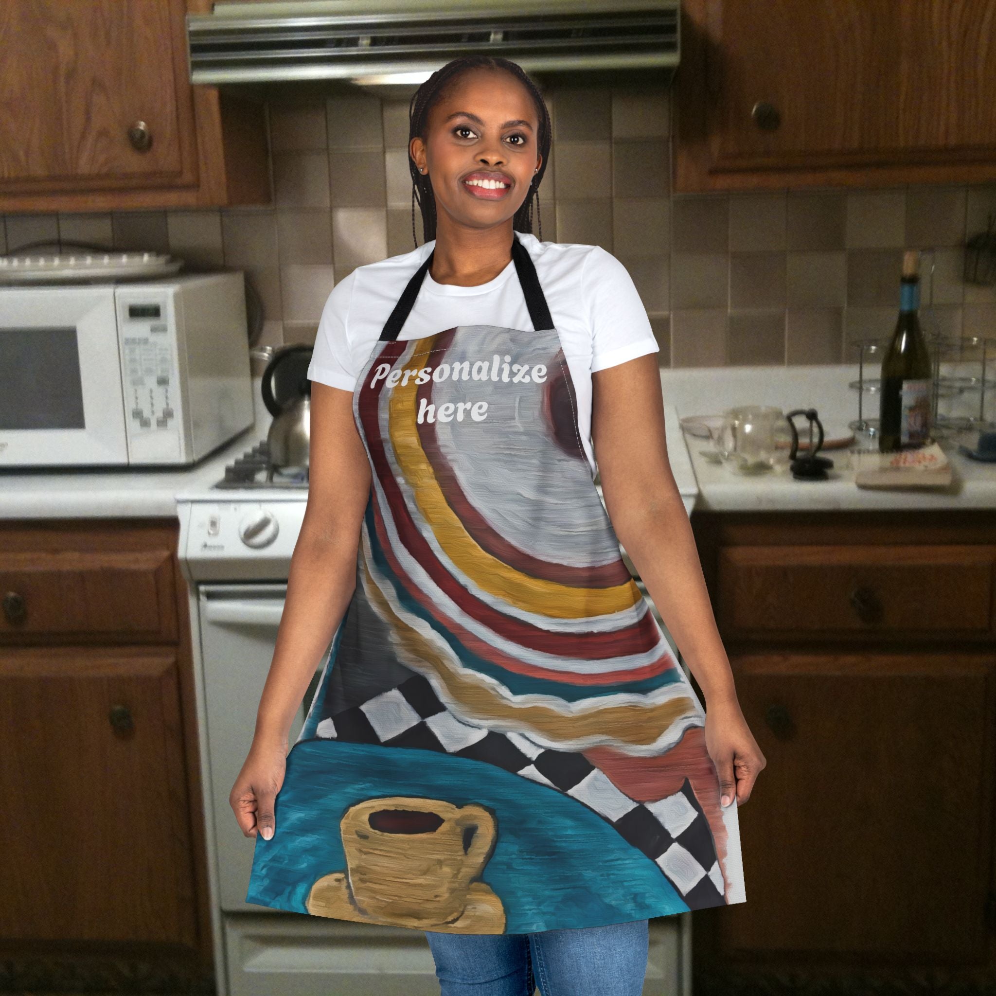 Woman wearing a colorful apron with a coffee cup design in a kitchen.