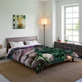 Bedroom with a bed featuring a christmas themed comforter, a lamp, and a painting on the wall.
