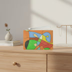 Colorful abstract design pouch on a wood dresser with a small vase and jewelry holder in the backgroun
