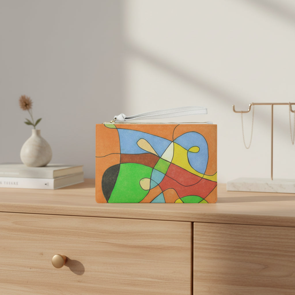 Colorful abstract design pouch on a wood dresser with a small vase and jewelry holder in the backgroun
