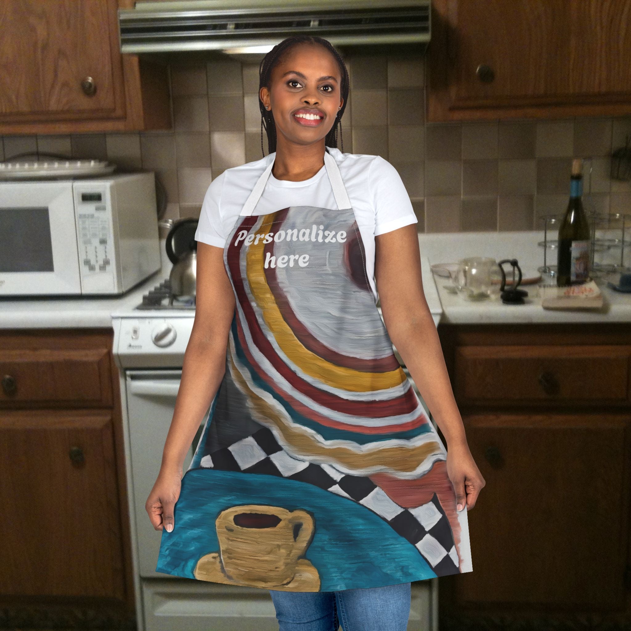 Woman wearing a colorful apron with a coffee cup design in a kitchen.