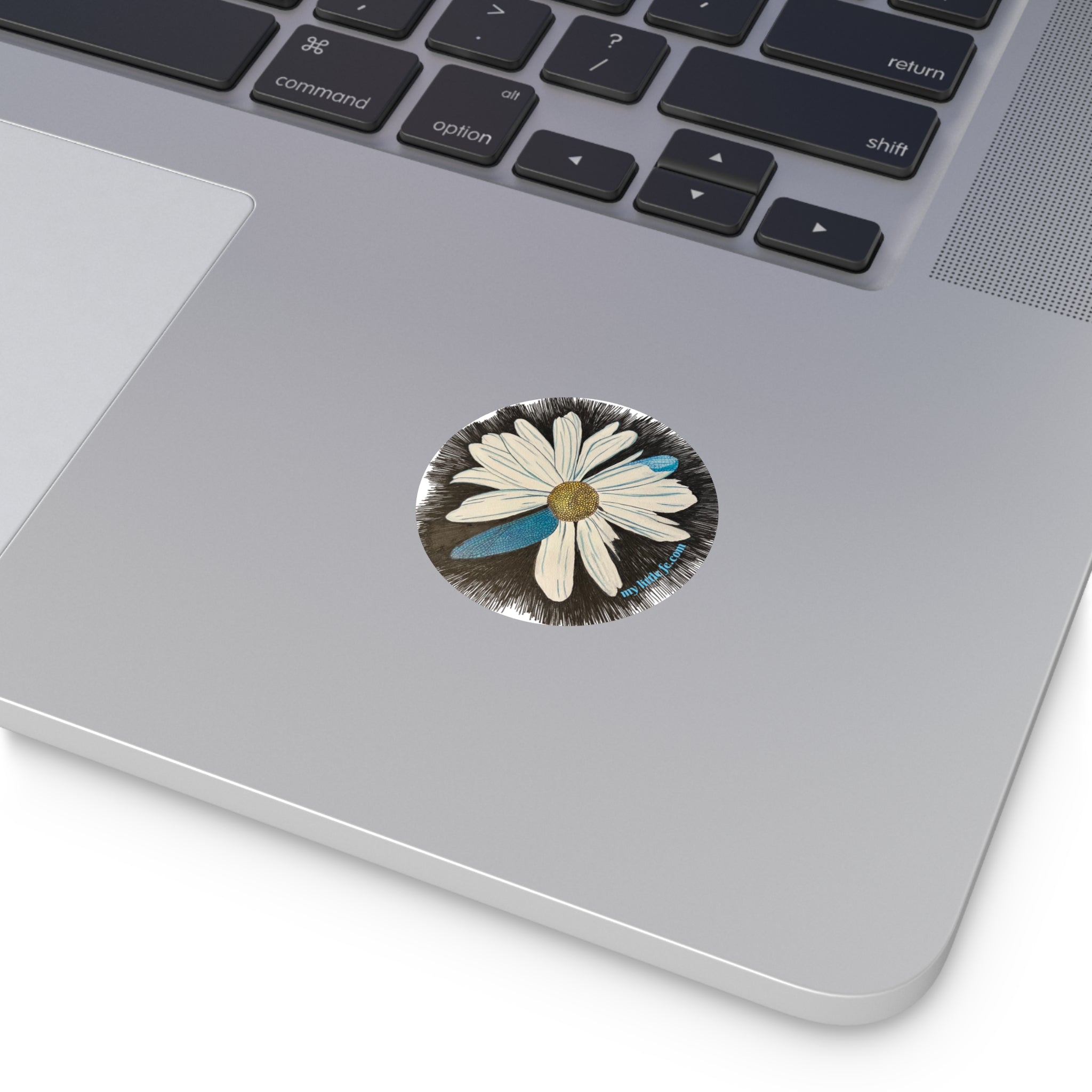 daisy with dragonfly petals design on a black background on a textured surface sticker on a laptop