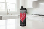 Water bottle with a red heart and 'be kind' text on a black background