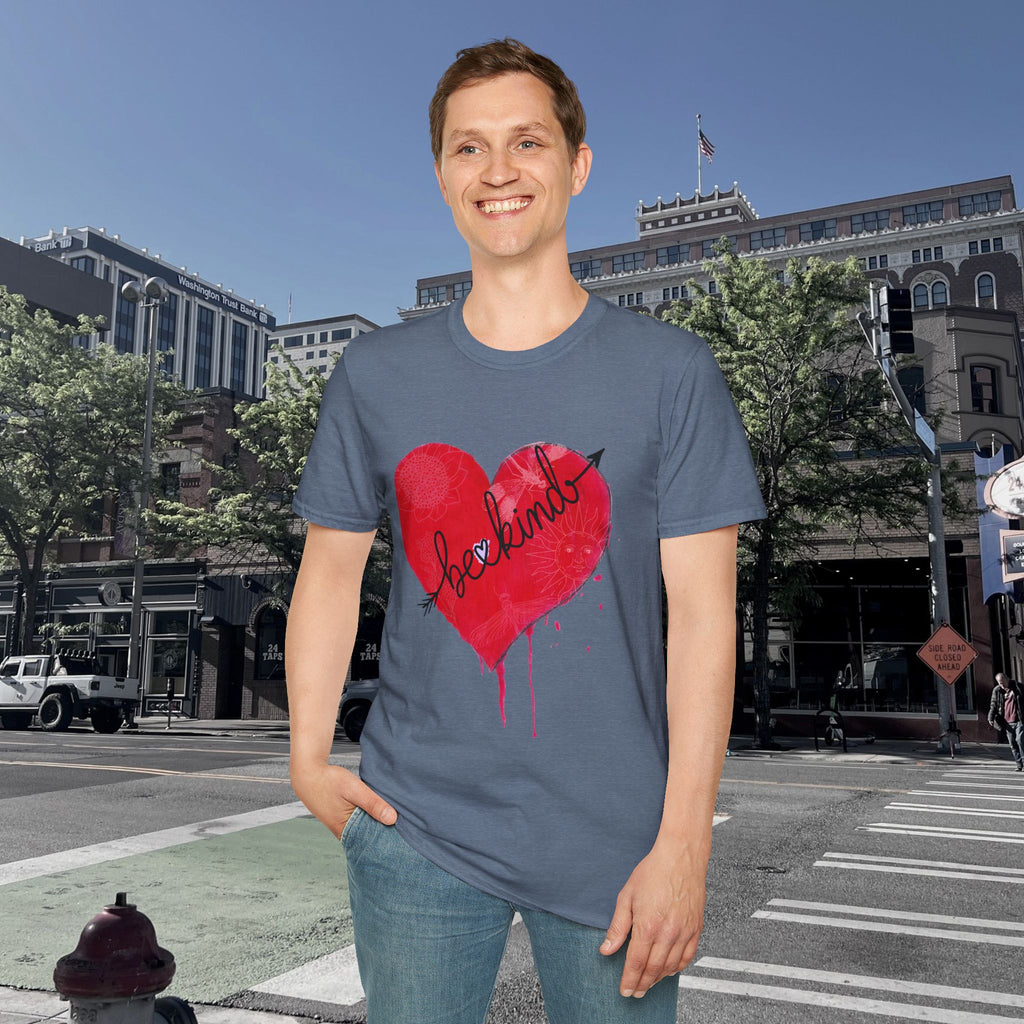 Person wearing a blue t-shirt with a red heart graphic on a city street