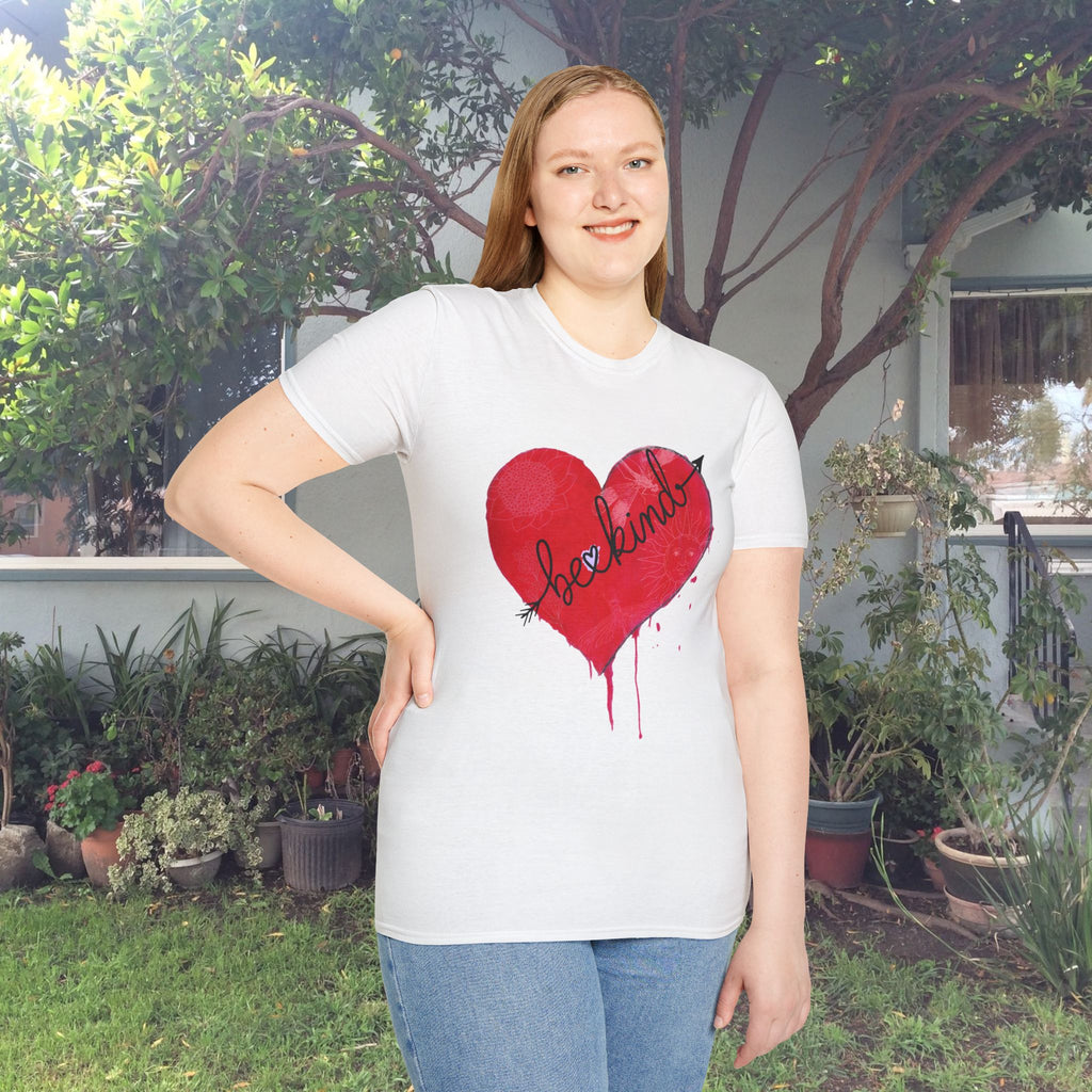 Person wearing a white t-shirt with a red heart design outdoors