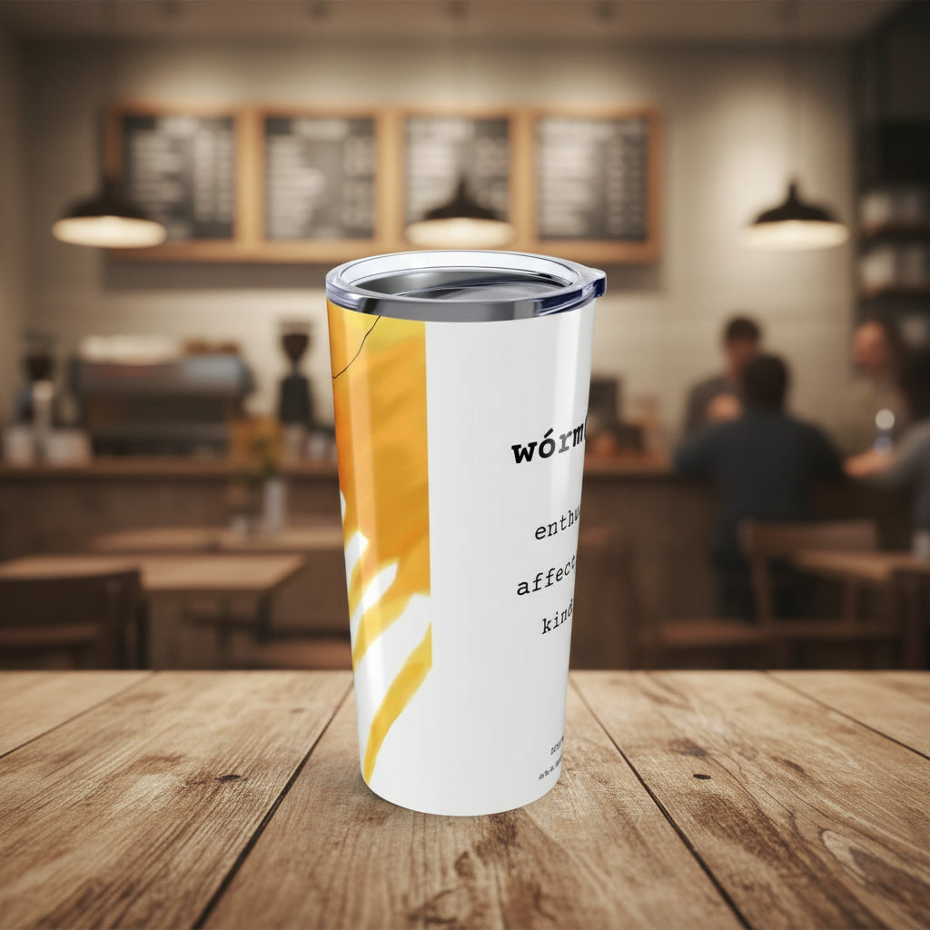 White tumbler with yellow design and text in a cafe
