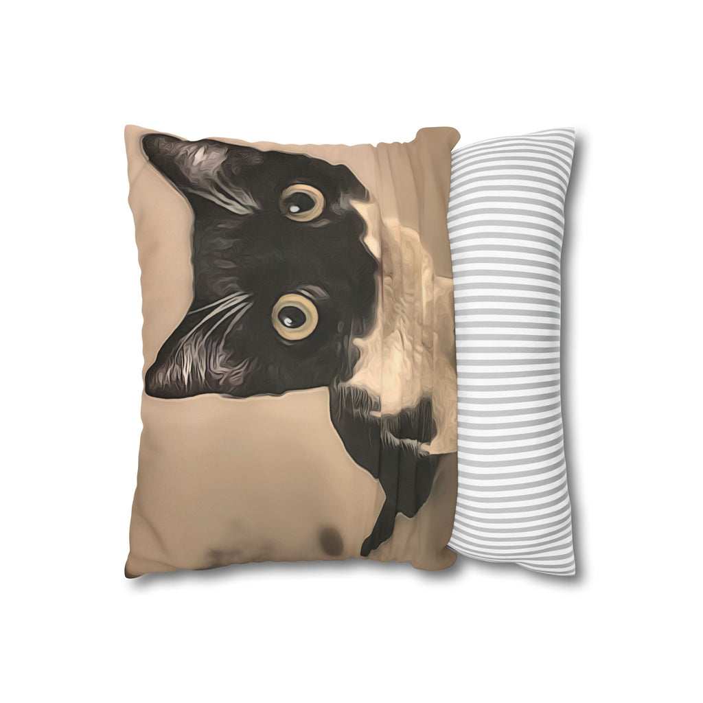 Decorative pillow with a black cat design on a beige background, next to a striped pillow.
