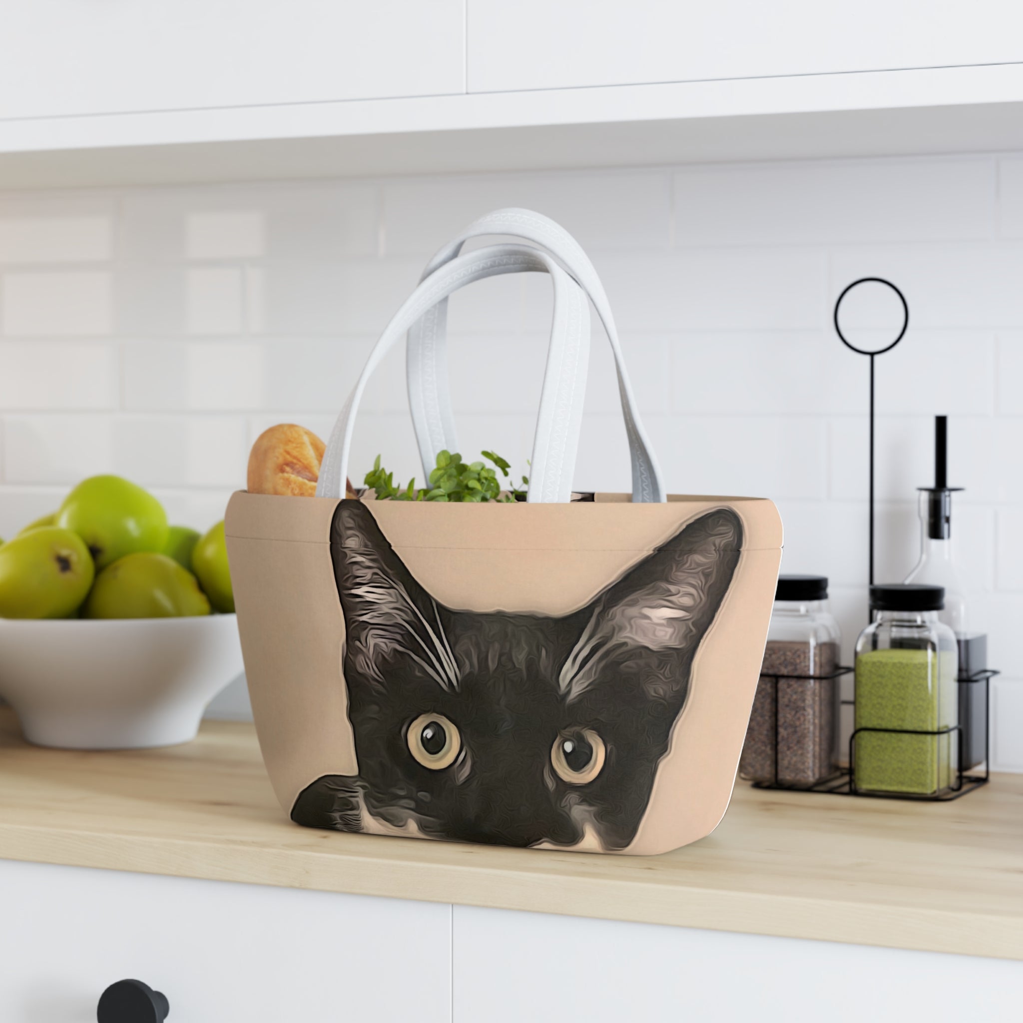 Beige tote bag with a black cat design on a kitchen counter.