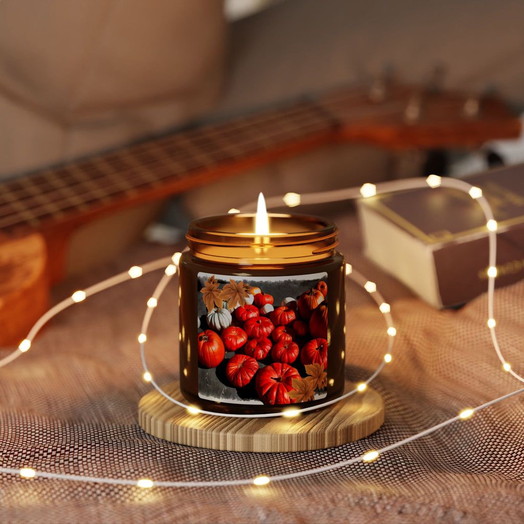 Candle with pumpkin design on a wooden coaster surrounded by string lights, with a guitar in the background.