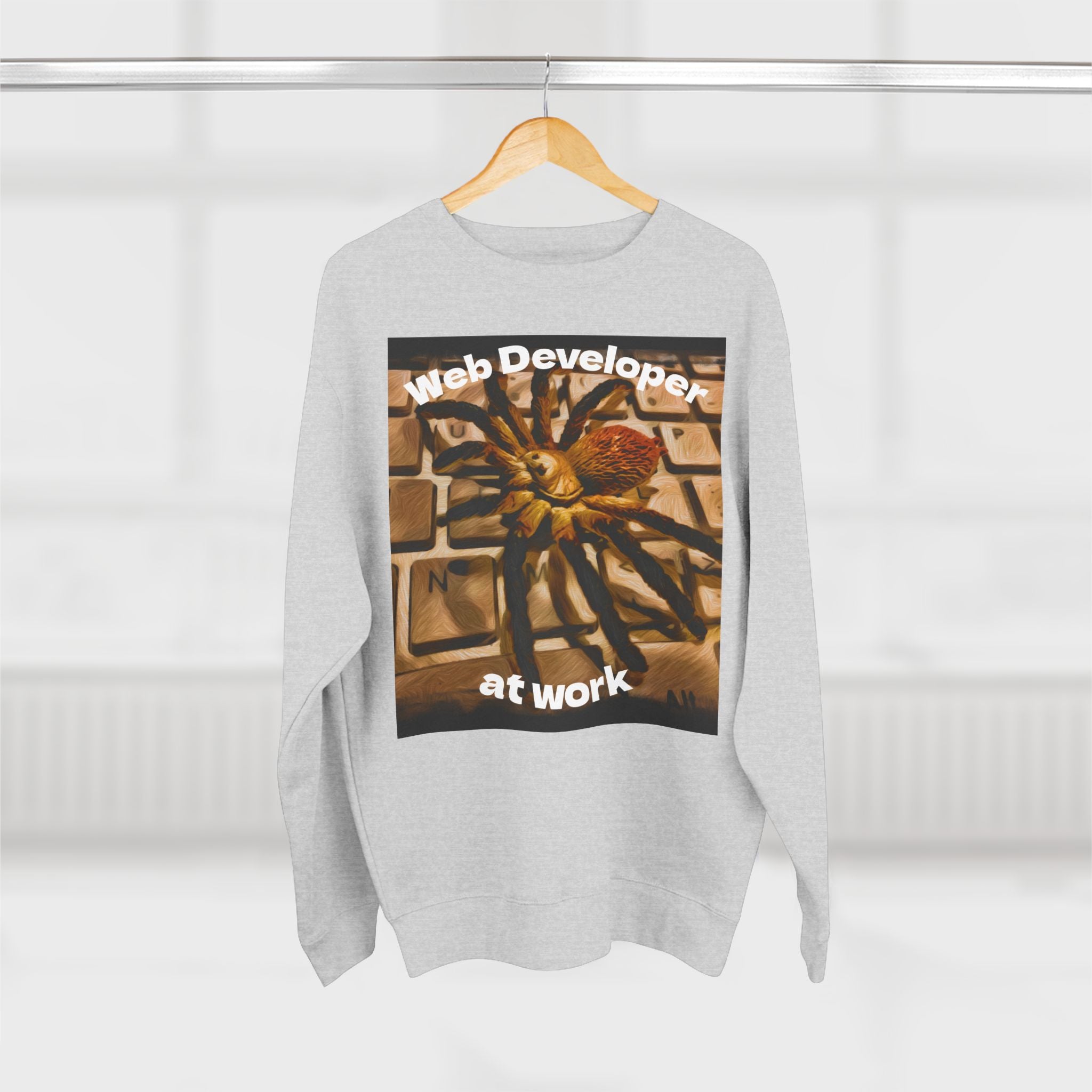 Gray sweatshirt with a spider on a keyboard design on a hanger against a white background