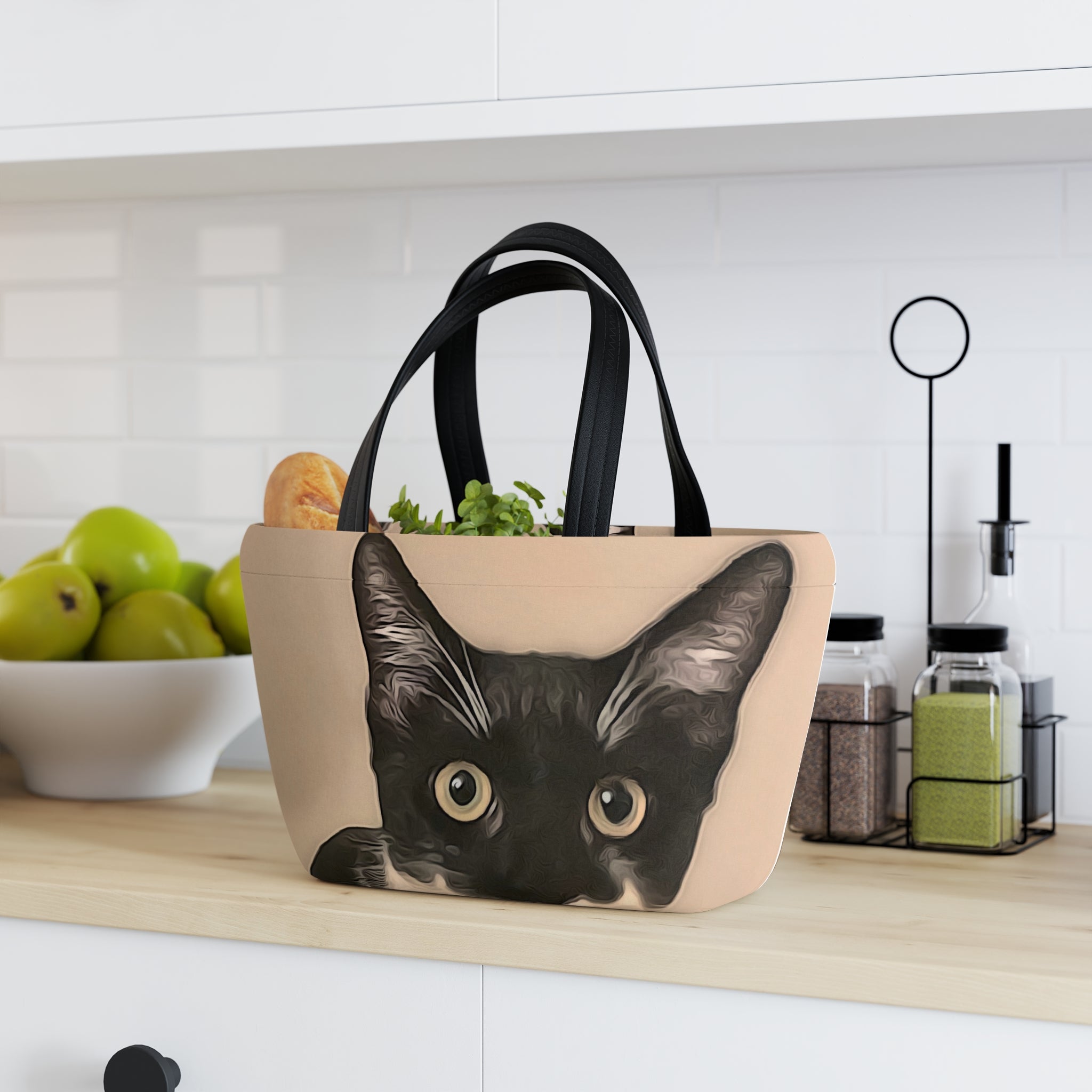 Beige tote bag with a black cat design on a kitchen counter.