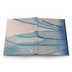 Book with dragonfly wings illustration and text 'spread your wings' on a white background