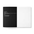 Open notebook with text on a black and white background
