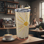 Tumbler with sun design and 'Text Here' text in a cafe