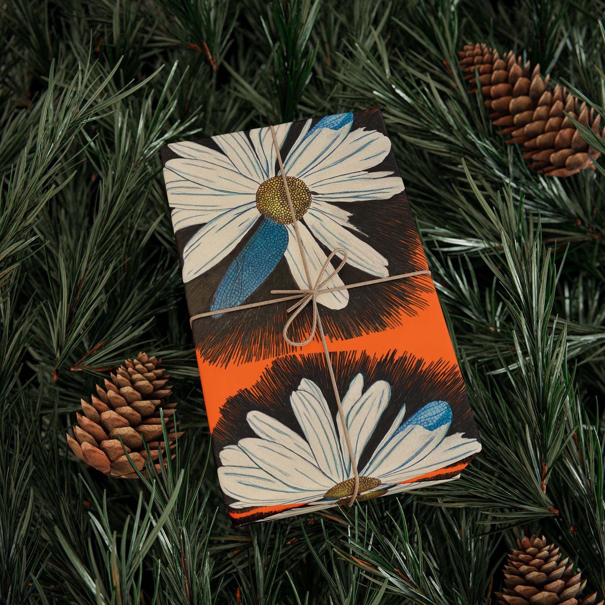 Floral-patterned product on a green leafy background with pine cones