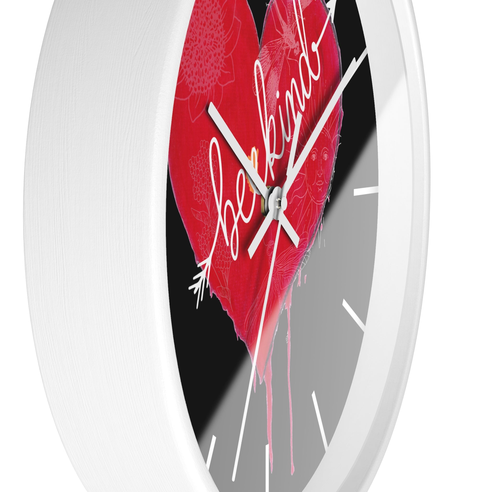 Wall clock with a red heart design and 'Be Kind' text on a white background