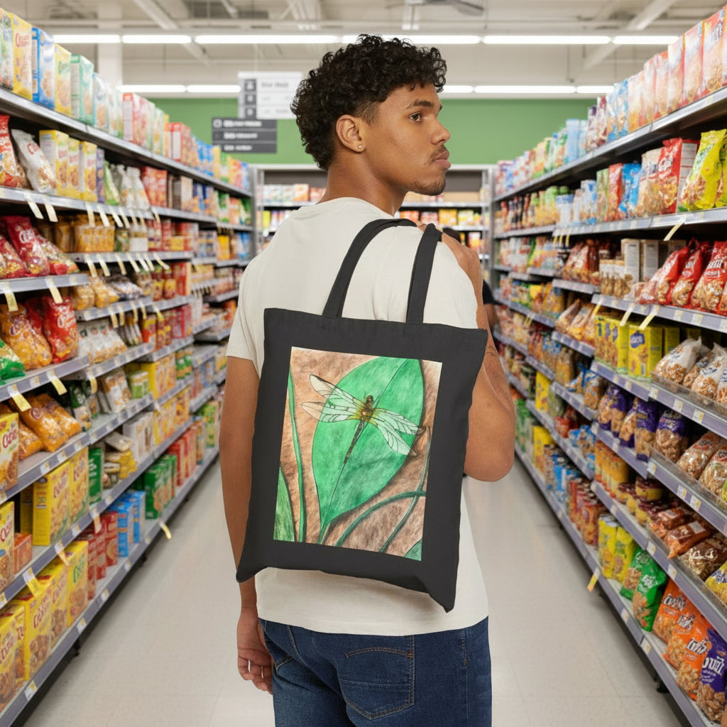 Man wearing a black tote bag with a dragonfly design at a grocery store
