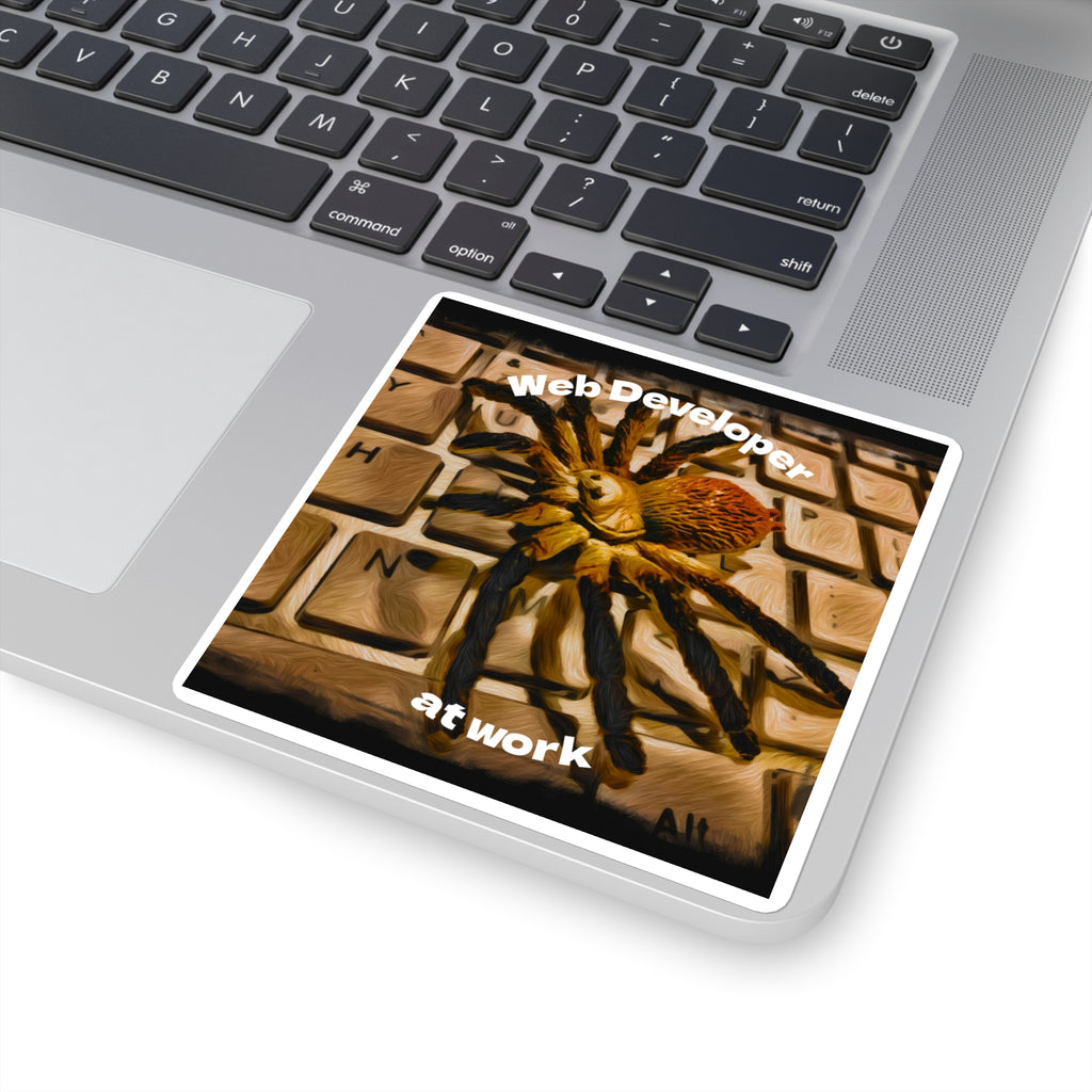 Laptop with a spider-themed 'Web Developer at Work' sticker on the palm rest area.