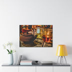 Framed artwork of a teapot and glasses on a wall above a shelf with decor items.