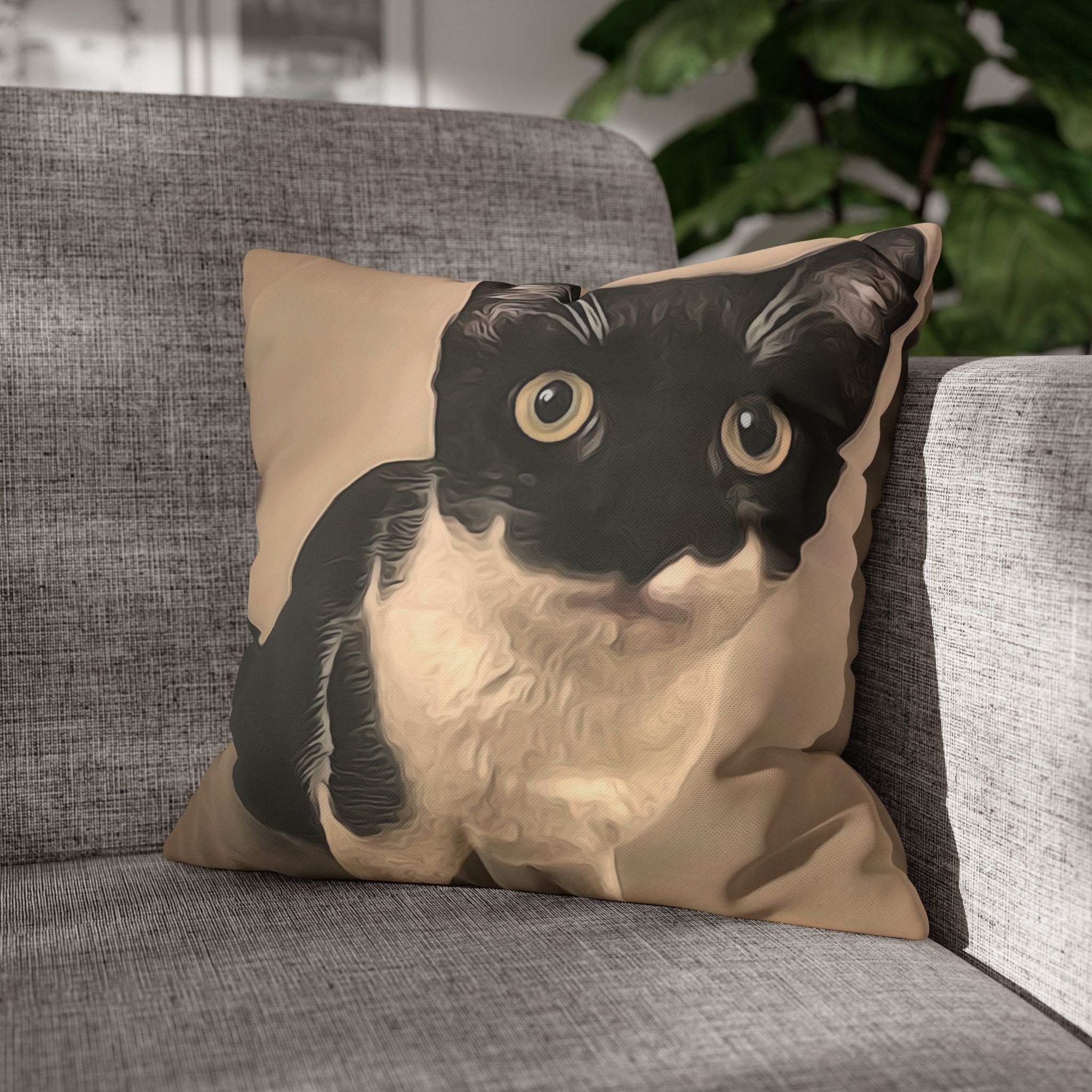Pillow with a cat design on a gray couch