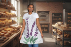 Woman wearing a white apron with purple and green floral design on a white background