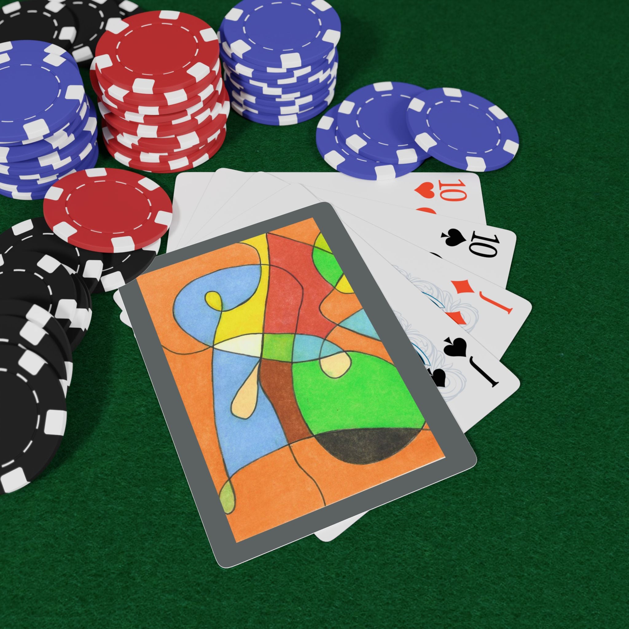 Colorful playing cards and poker chips on a green felt surface