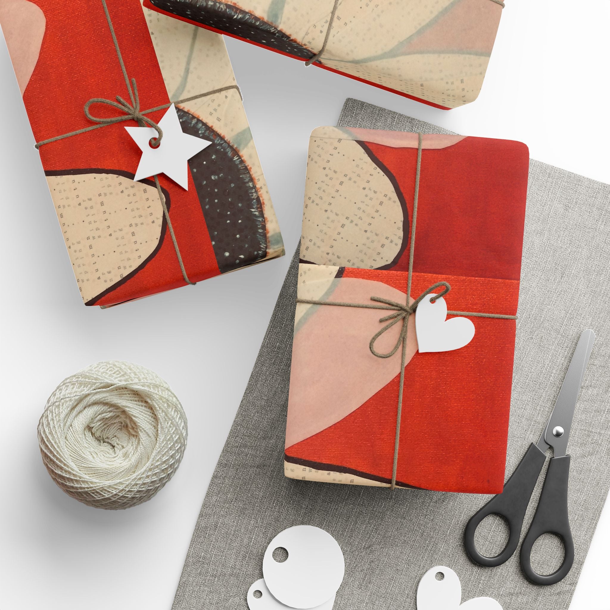 Gift-wrapped packages with decorative paper, string, and scissors on a white surface.
