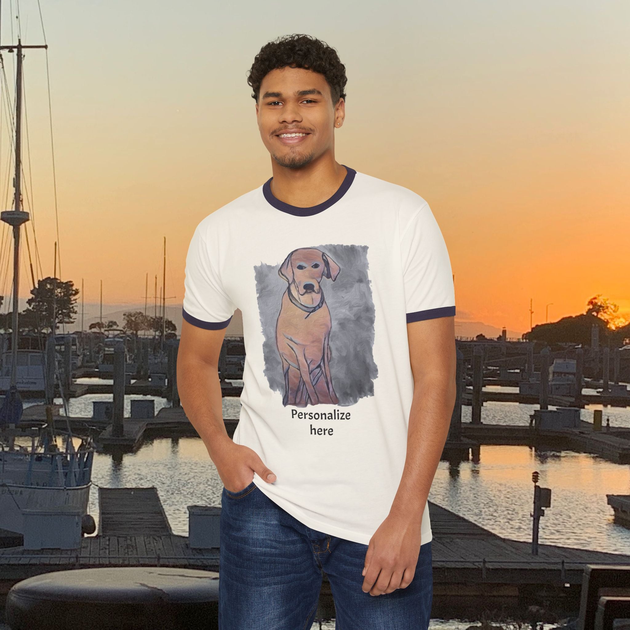 Man wearing a t-shirt with a dog graphic and text at a marina during sunset.