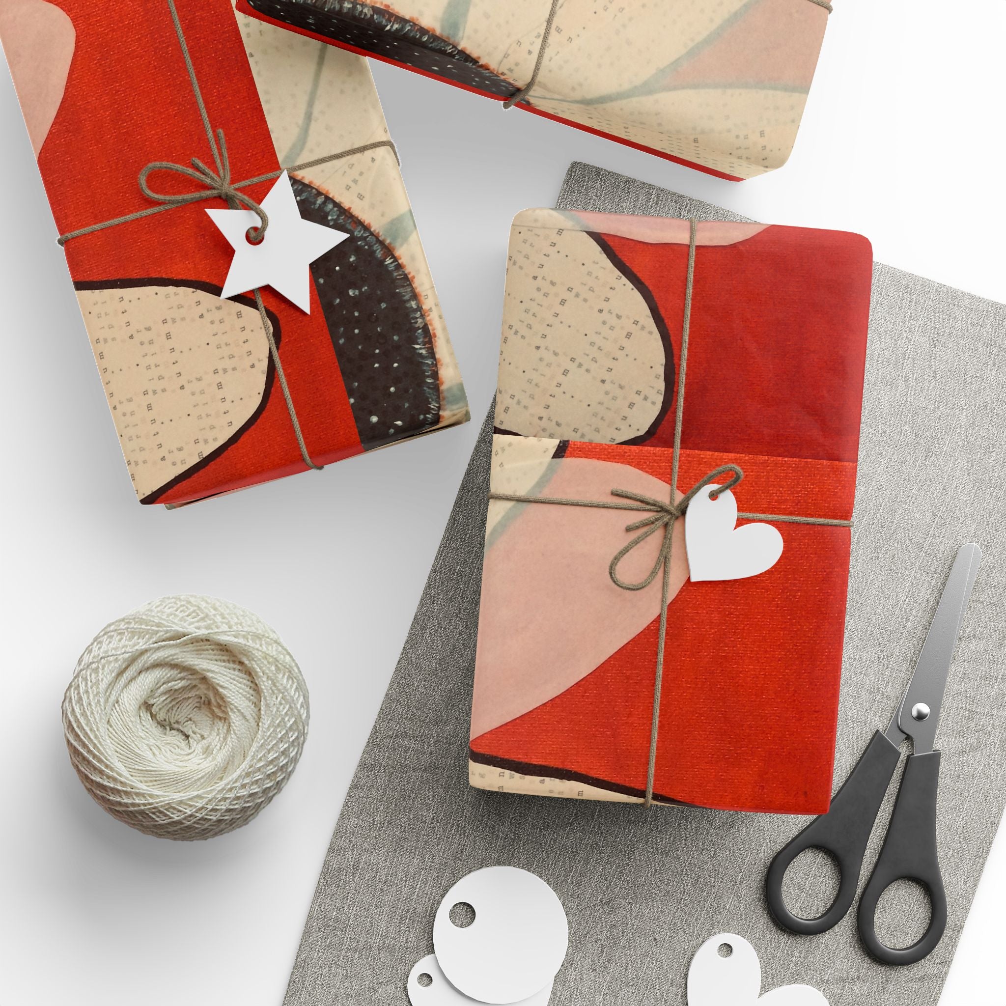 Gift-wrapped packages with decorative paper, string, and scissors on a white surface.