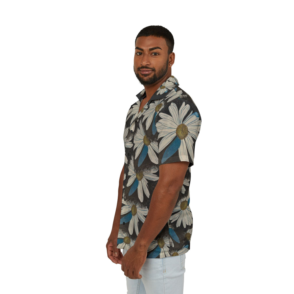 A man wearing a short-sleeve button-up shirt with a large white daisy floral print on a dark gray background, paired with light blue jeans, photographed against a solid white studio background.