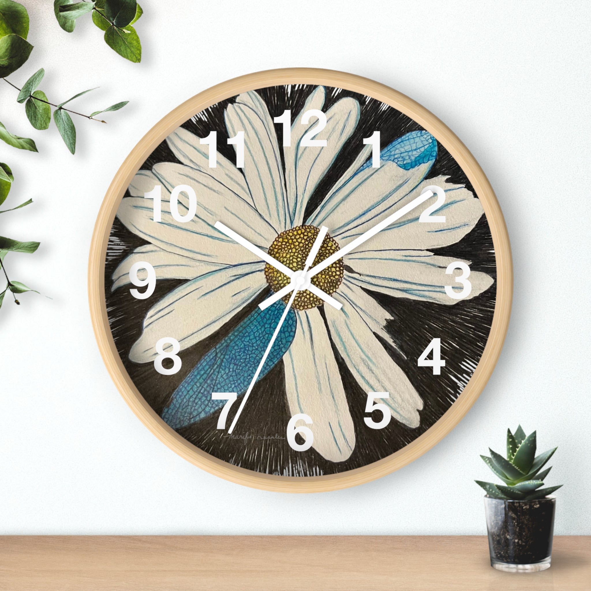 Decorative wall clock with a floral design on a white background