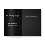 Open book with text on dark mode preference and a humorous response.